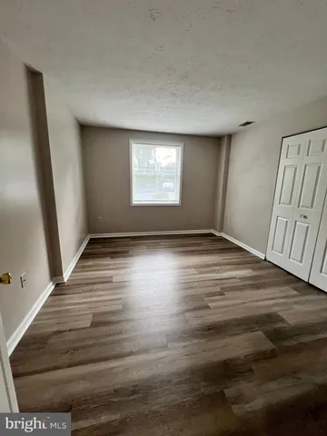a front of a brick building with sign board