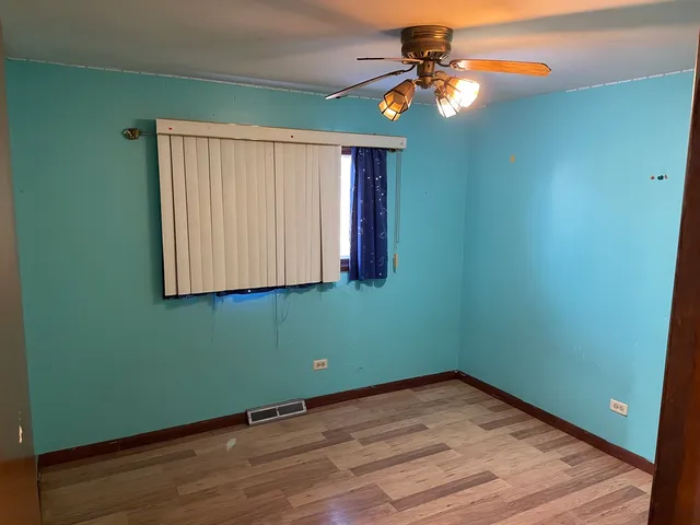 a room with window and chandelier fan