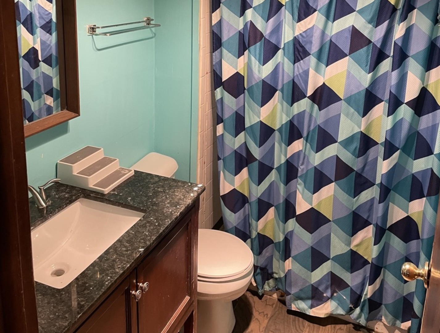 14540 Kolin Avenue Midlothian, IL 60445 - Photo 18 of 24 a bathroom with a sink a toilet and a shower curtain