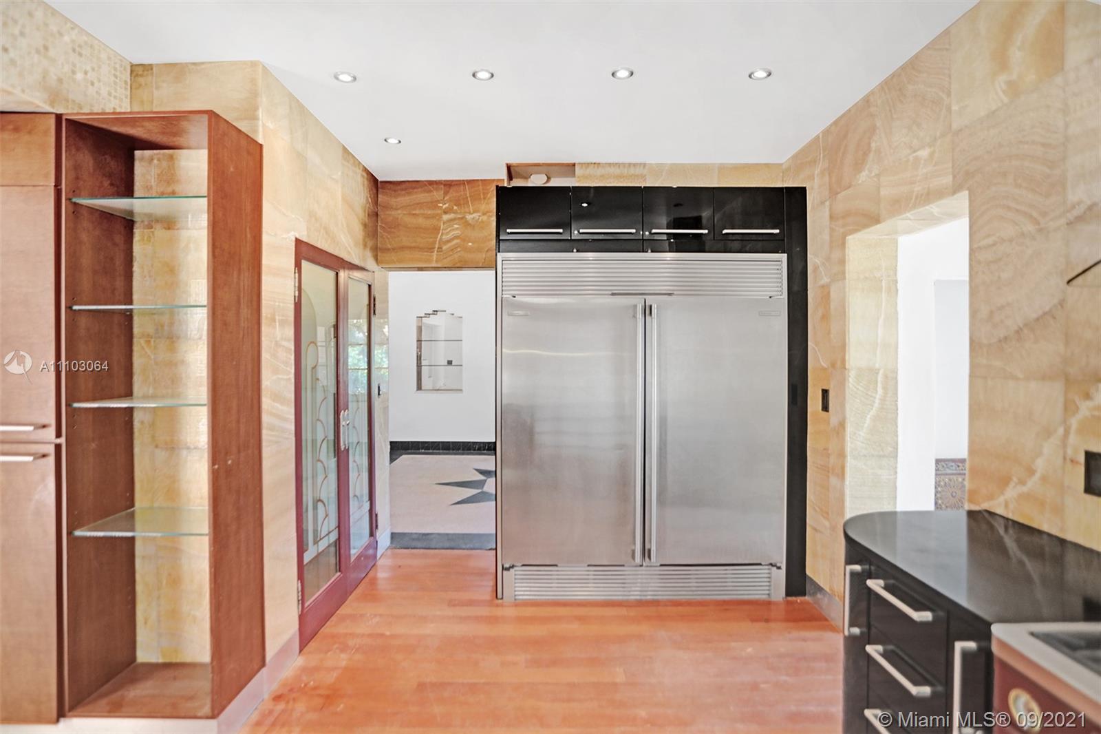 4431 Alton Road Miami Beach, FL 33140 - Photo 17 of 58 a view of kitchen with stainless steel appliances granite countertop cabinets and refrigerator