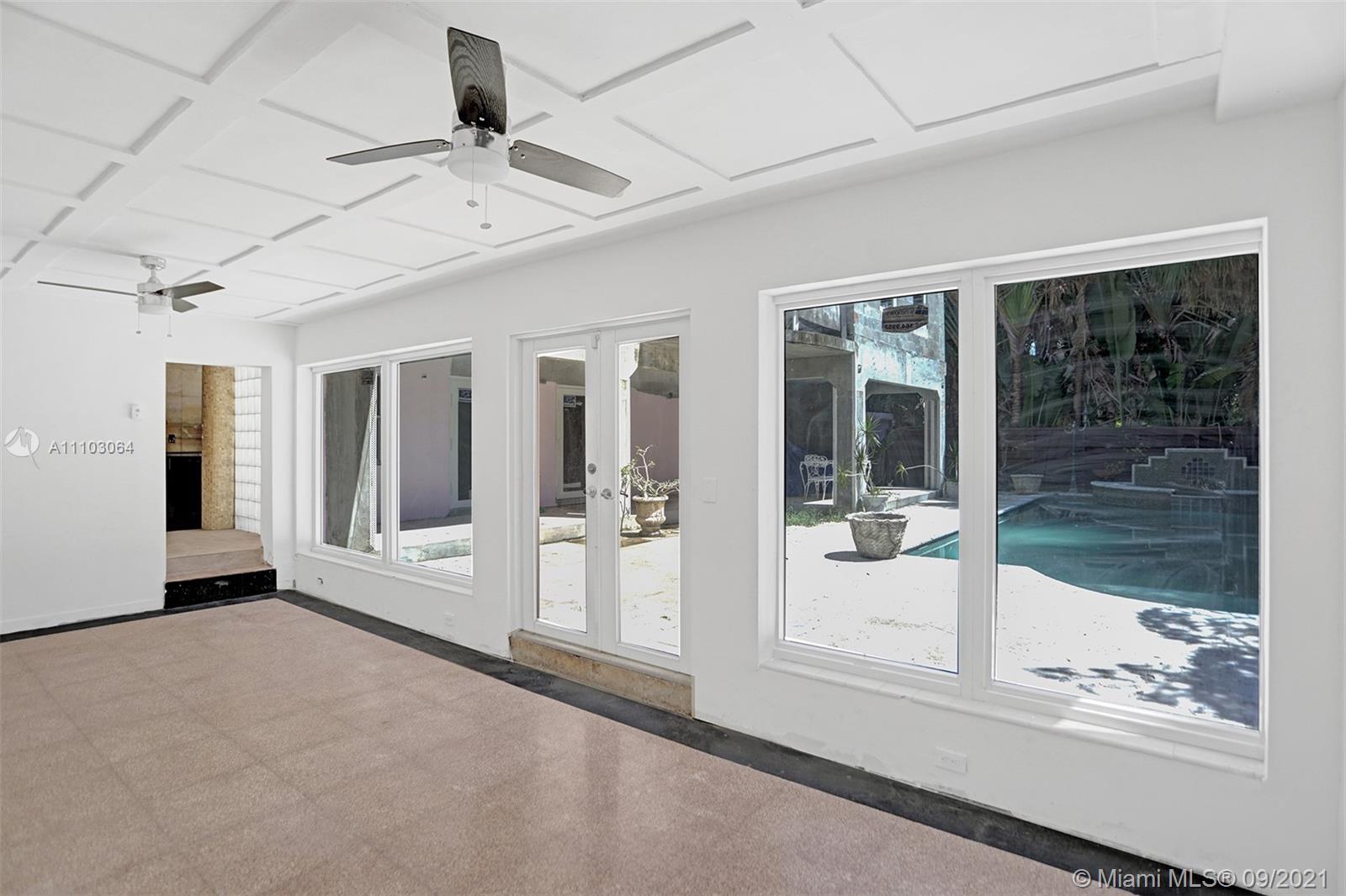 4431 Alton Road Miami Beach, FL 33140 - Photo 19 of 58 a view of a glass door with a glass door