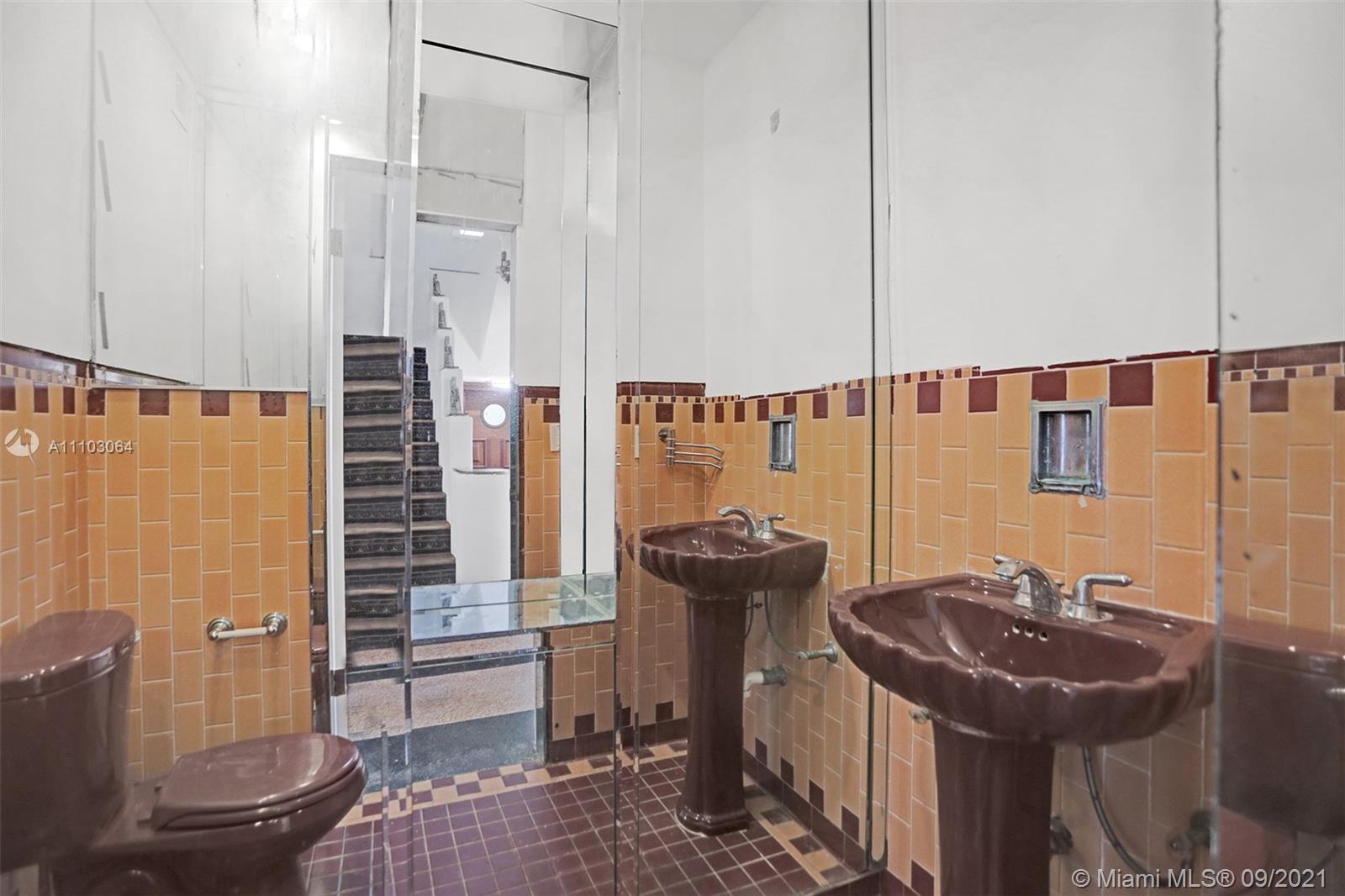4431 Alton Road Miami Beach, FL 33140 - Photo 22 of 58 a bathroom with a sink a toilet and shower