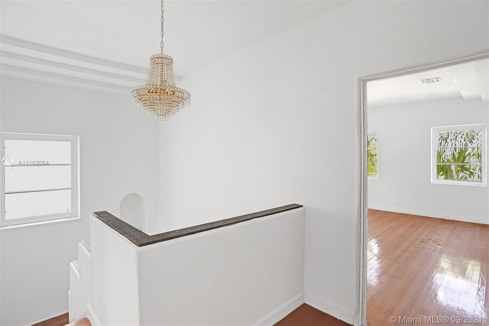 4431 Alton Road Miami Beach, FL 33140 - Photo 31 of 58 a view of a hallway with a refrigerator and dishwasher