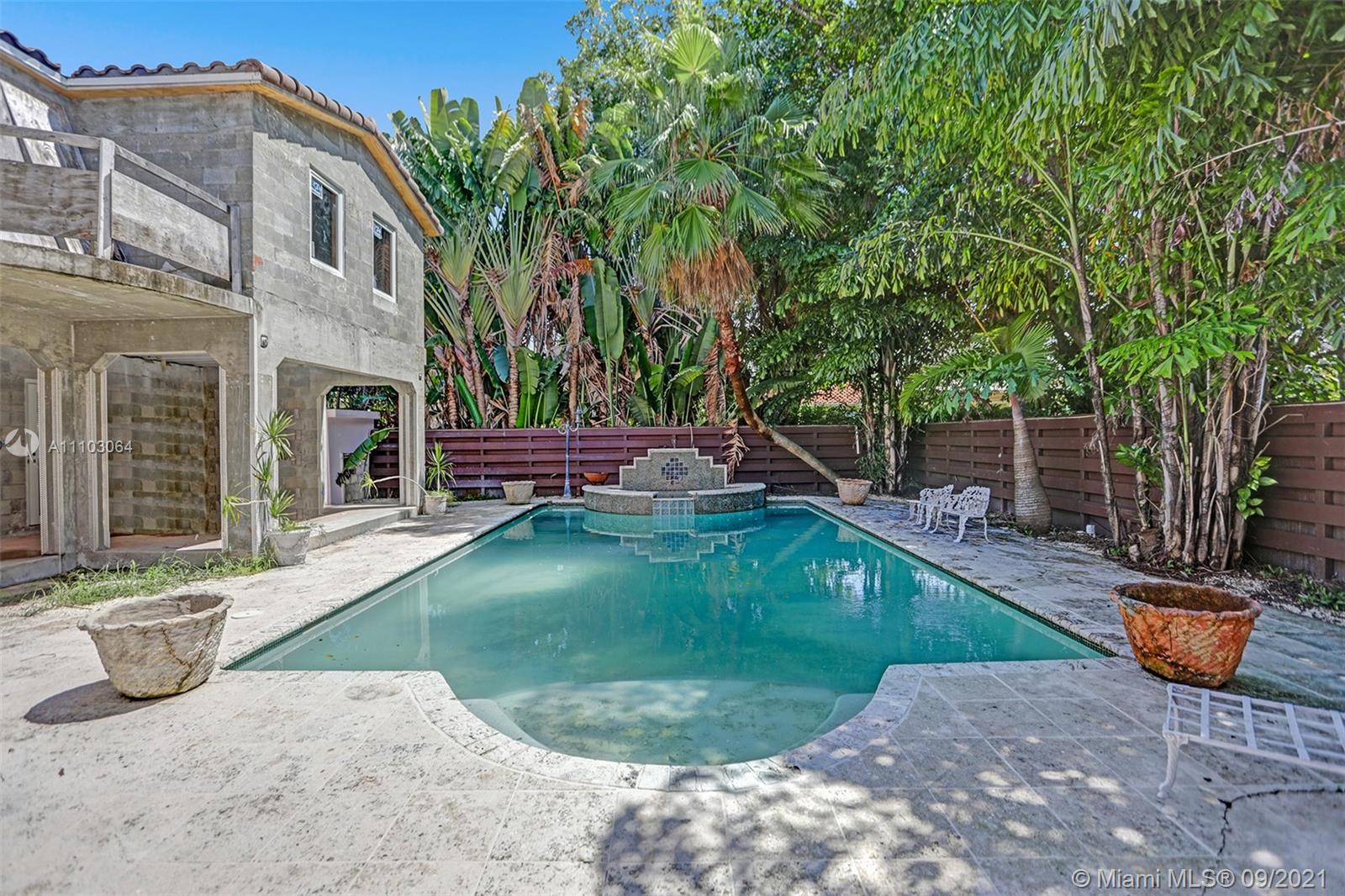 4431 Alton Road Miami Beach, FL 33140 - Photo 36 of 58 a view of a chair and tables in the backyard of the house