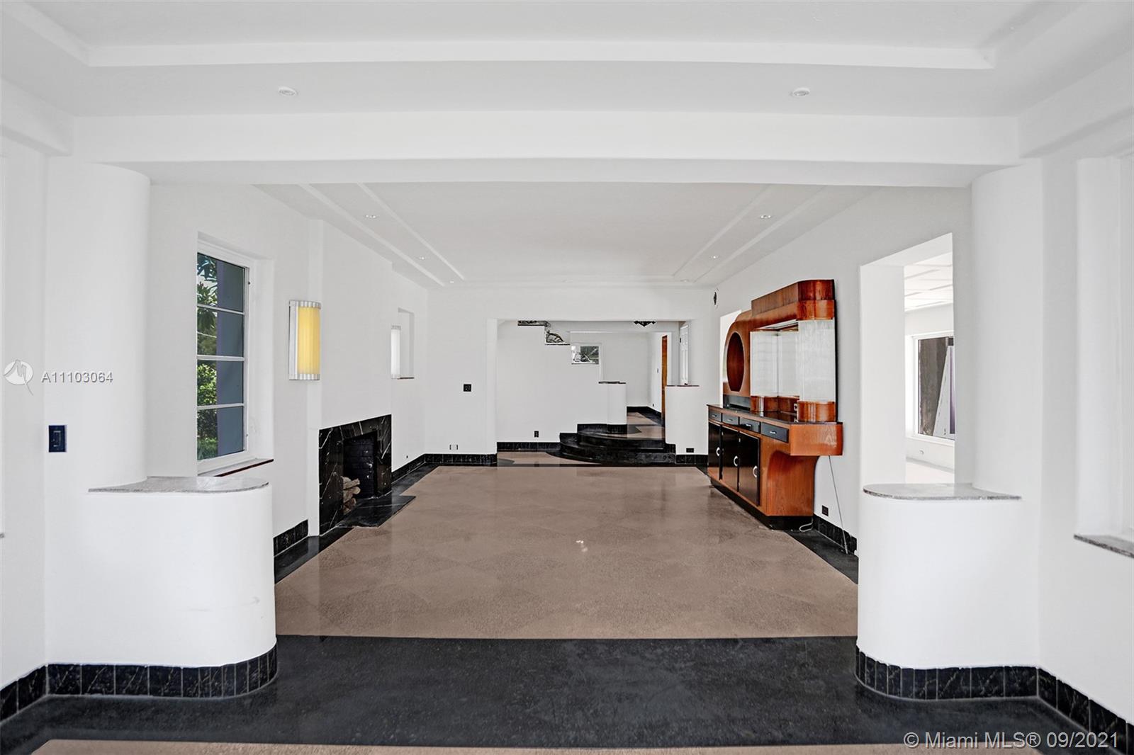 4431 Alton Road Miami Beach, FL 33140 - Photo 6 of 58 a living room with furniture and a fireplace