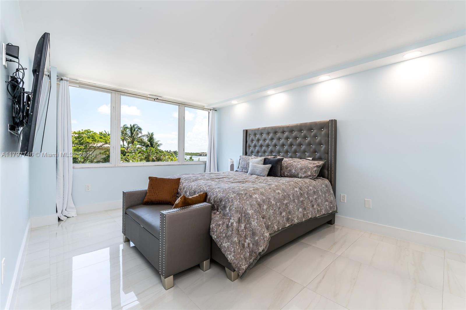 3912 South Ocean Boulevard, Unit 306 Highland Beach, FL 33487 - Photo 11 of 25 a bedroom with a bed and a couch
