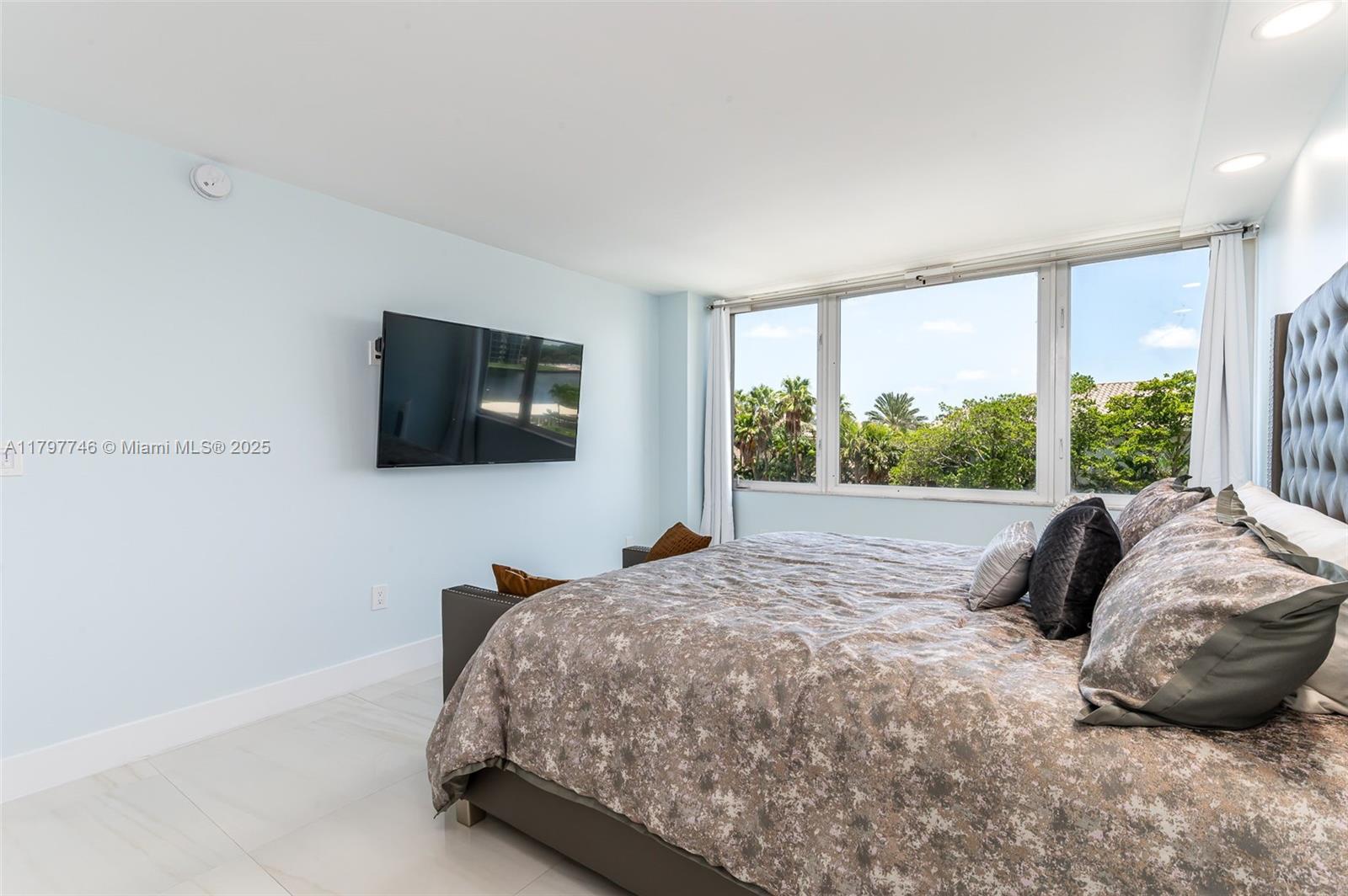 3912 South Ocean Boulevard, Unit 306 Highland Beach, FL 33487 - Photo 12 of 25 a bedroom with a bed and a flat screen tv
