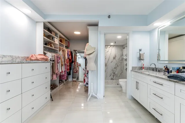 a bathroom with a granite countertop sink vanity mirror next to a cabinet
