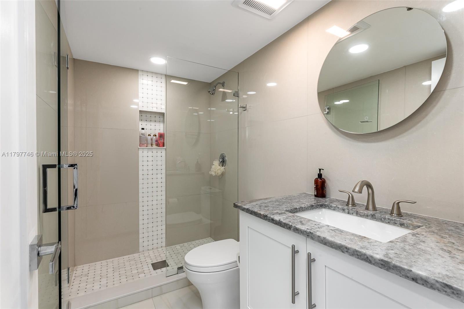 3912 South Ocean Boulevard, Unit 306 Highland Beach, FL 33487 - Photo 17 of 25 a bathroom with a granite countertop sink toilet and shower