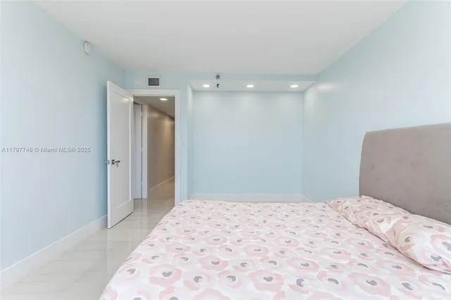 a bedroom with a bed and a mirror