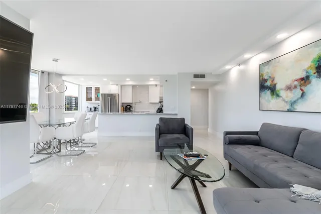 a living room with furniture kitchen view and a painting