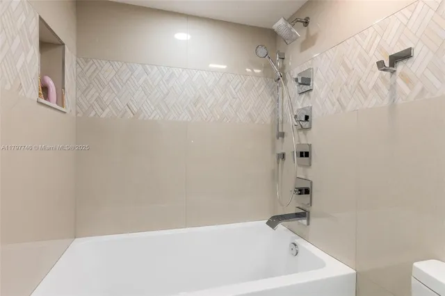 a bathroom with a bathtub and shower