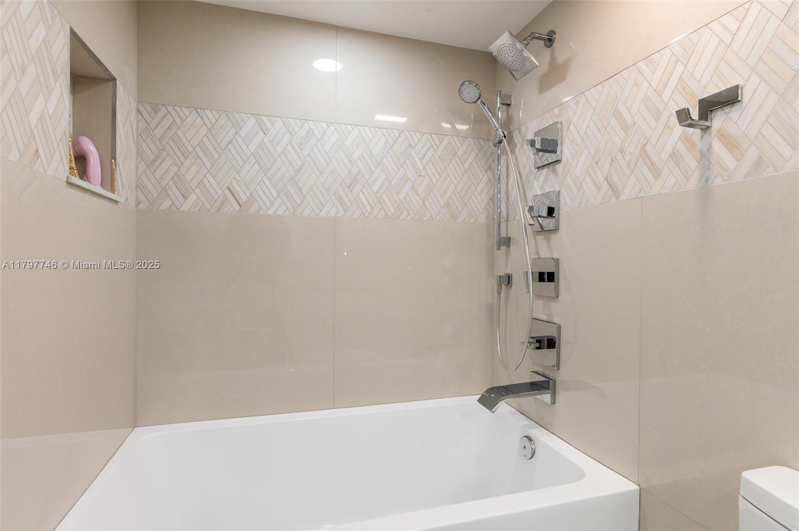 3912 South Ocean Boulevard, Unit 306 Highland Beach, FL 33487 - Photo 8 of 25 a bathroom with a bathtub and shower