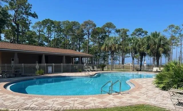 a swimming pool with outdoor seating and yard