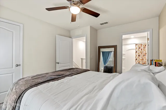 a bedroom with a bed and a chandelier