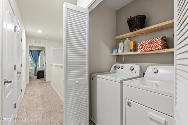 a view of storage and utility room with washer and dryer