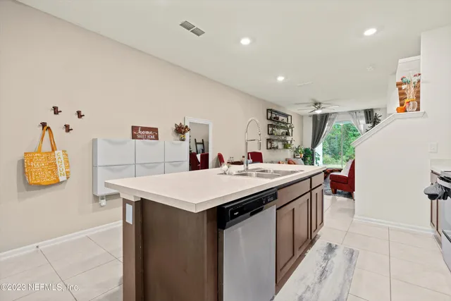 a kitchen with a sink and a refrigerator
