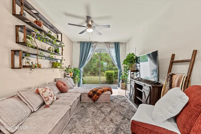 a living room with furniture fireplace and flat screen tv