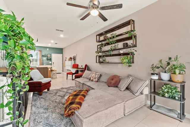a bedroom with furniture and a potted plant