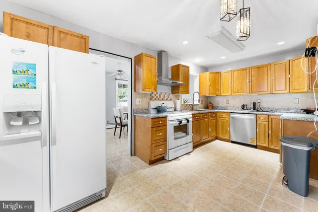a kitchen with a refrigerator a sink and cabinets
