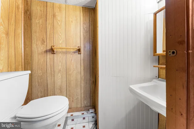 a white toilet sitting next to a bathroom sink