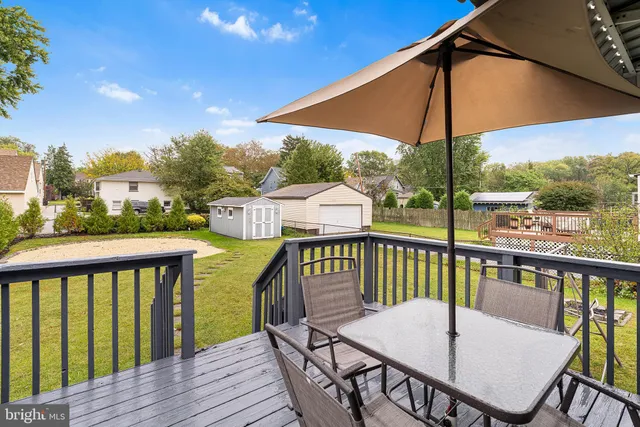 a view of a deck with furniture and umbrella