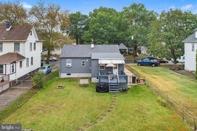 an aerial view of a house with swimming pool garden and patio