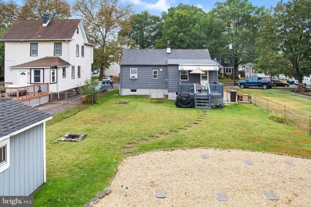 a aerial view of a house with swimming pool and a yard