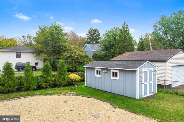 a aerial view of a house next to a yard with big trees