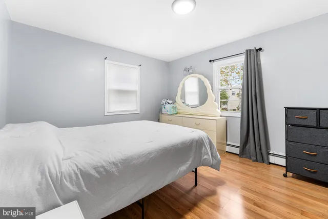 a bedroom with a bed and a dresser