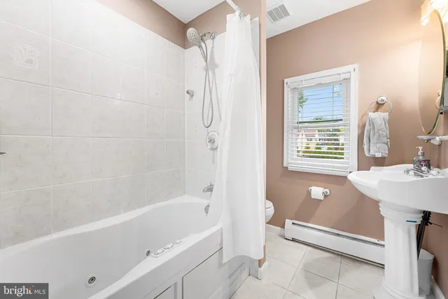 a bathroom with a sink a bathtub and a shower