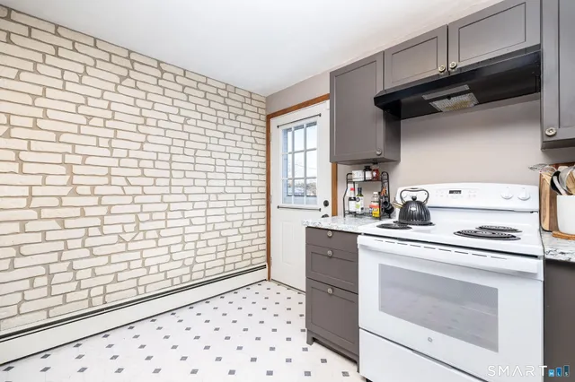 a kitchen with a stove a sink and a refrigerator