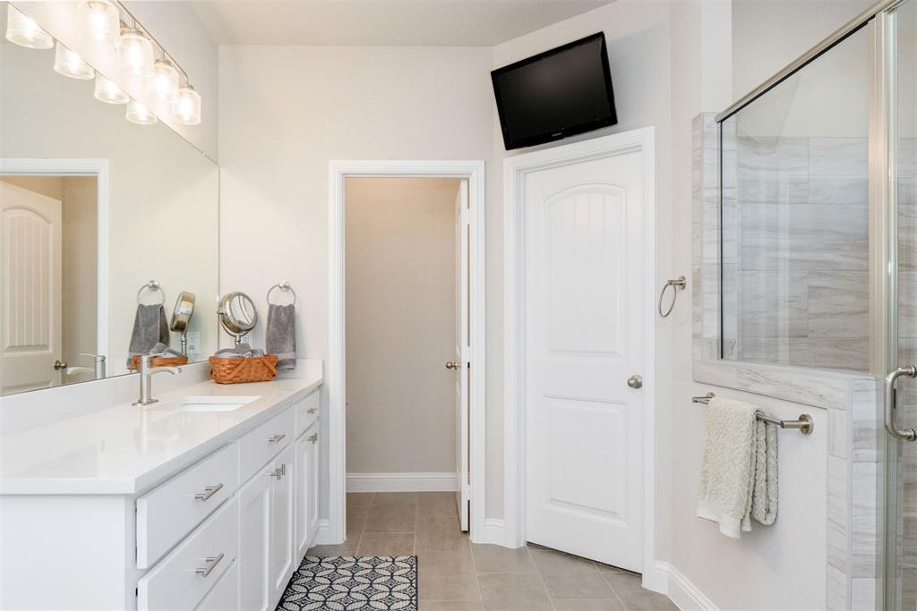 849 County Road 4764 Boyd, TX 76023 - Photo 20 of 40 a bathroom with a sink a toilet and shower