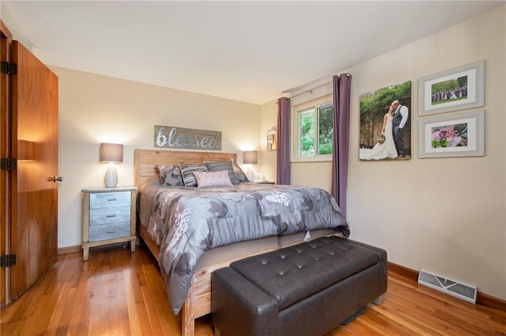 216 Hillendale Road Pittsburgh, PA 15237 - Photo 11 of 25 a bedroom with a bed and wooden floor