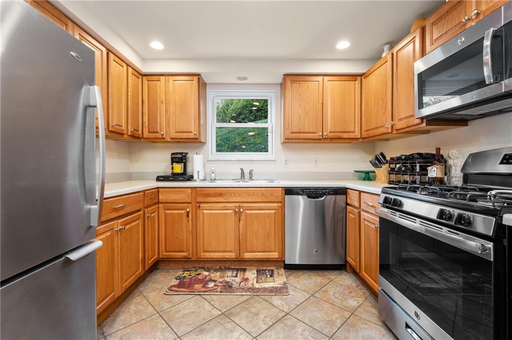 216 Hillendale Road Pittsburgh, PA 15237 - Photo 10 of 25 a kitchen with stainless steel appliances granite countertop a stove a sink and a microwave