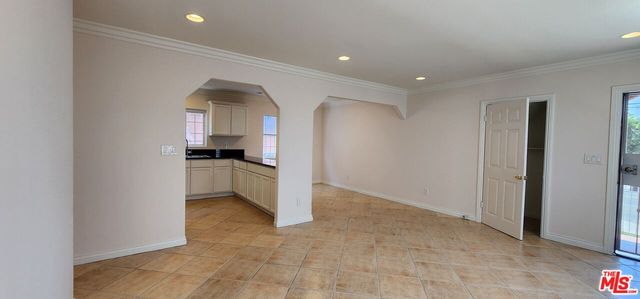 a view of kitchen with refrigerator stove and window