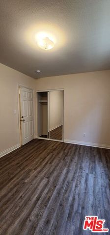 an empty room with wooden floor