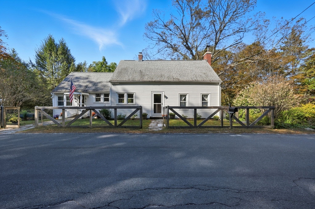 a view of a house with wooden fence