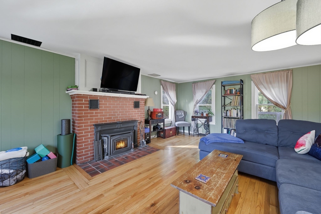 376 NW Road Westhampton, MA 01027 - Photo 26 of 41 a living room with furniture a flat screen tv and a fireplace