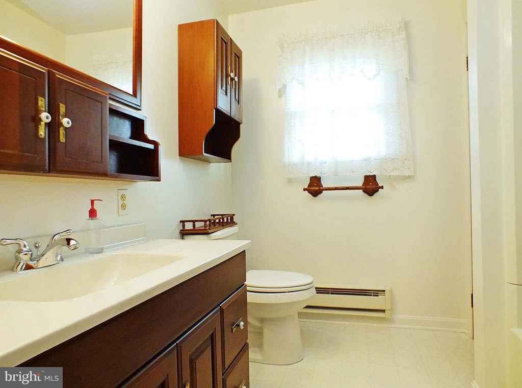 4519 Foxtail Road Hampstead, MD 21074 - Photo 11 of 29 a bathroom with a sink a toilet and a mirror