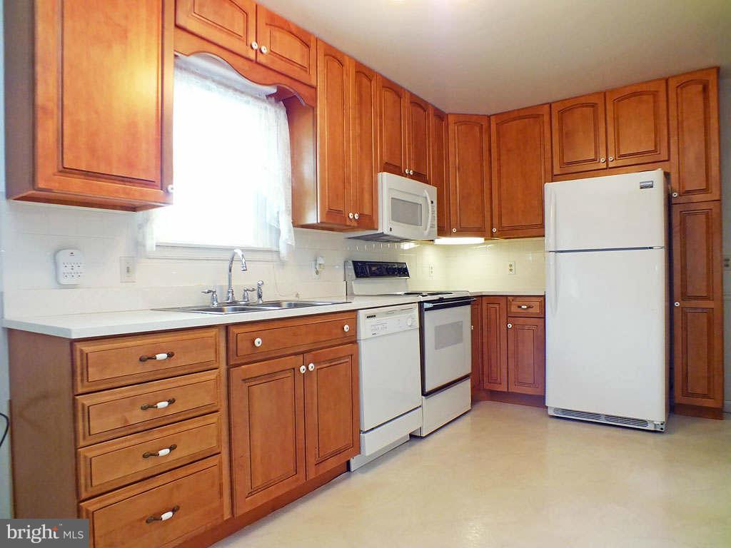 4519 Foxtail Road Hampstead, MD 21074 - Photo 5 of 29 a kitchen with cabinets appliances a sink and a window