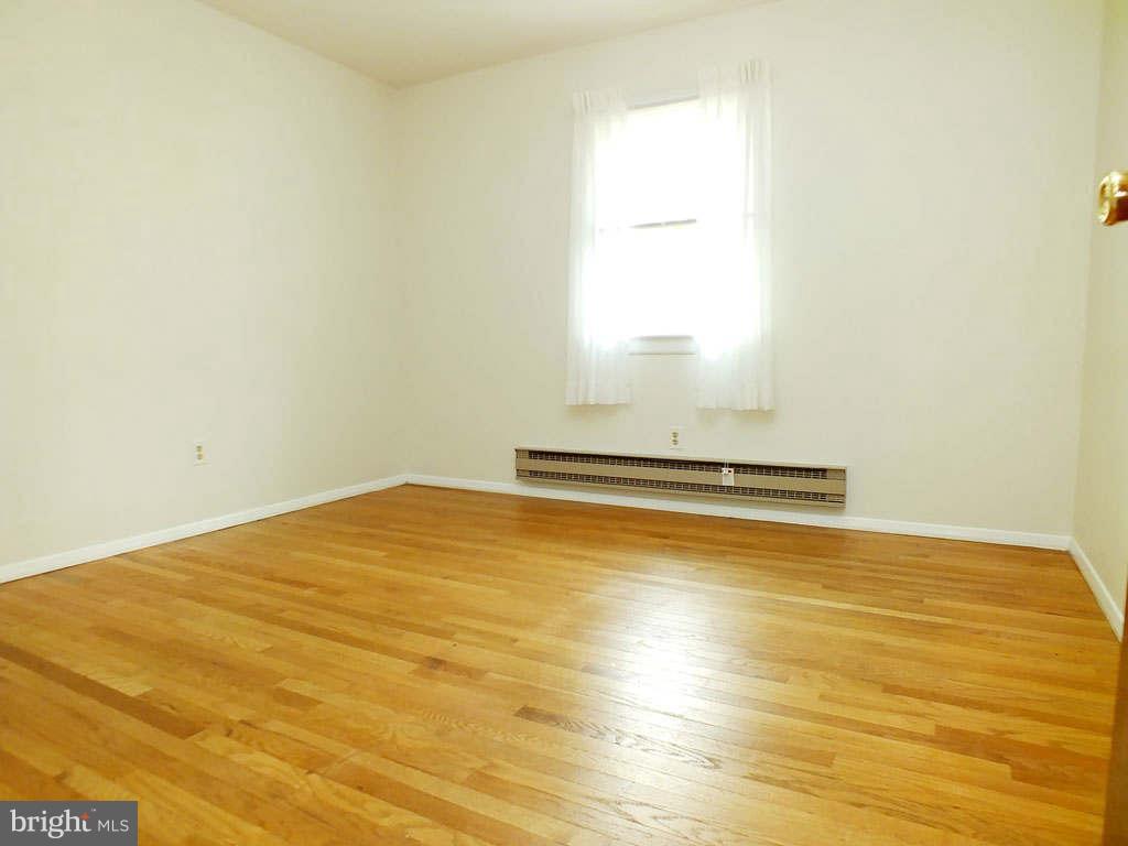 4519 Foxtail Road Hampstead, MD 21074 - Photo 9 of 29 a view of a room with wooden floor and white walls