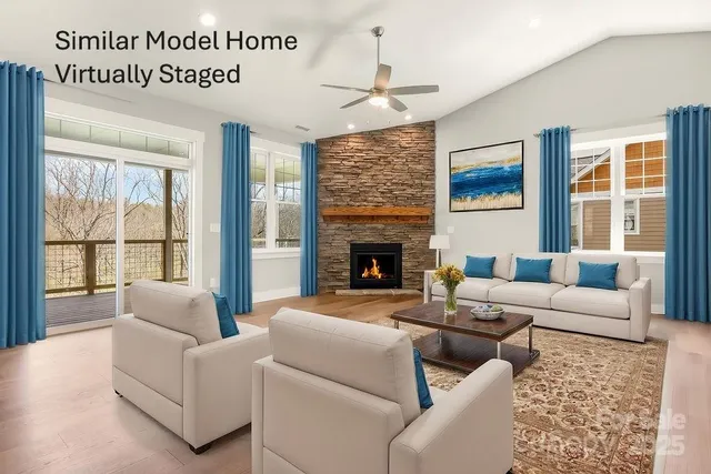 a living room with furniture windows and a fireplace