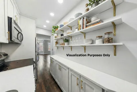 a kitchen with kitchen island white cabinets and wooden floor