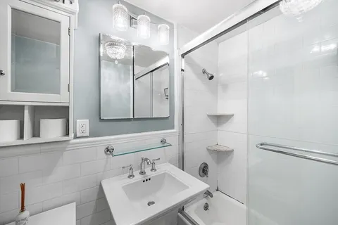 a bathroom with a toilet sink and mirror