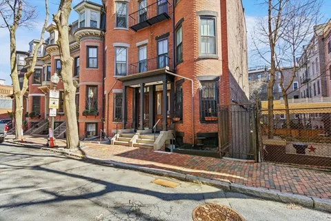 a view of a brick building with many windows