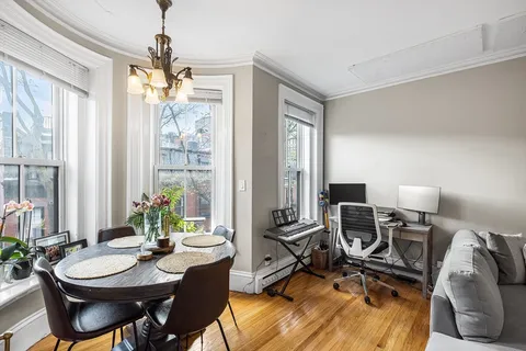 a view of a livingroom with furniture and a window