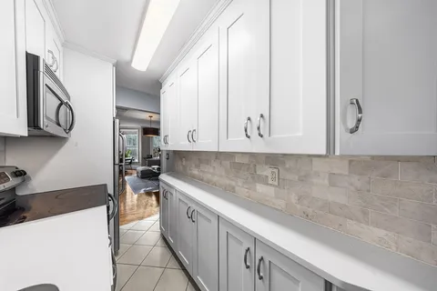 a kitchen with stainless steel appliances granite countertop a sink a stove and a microwave