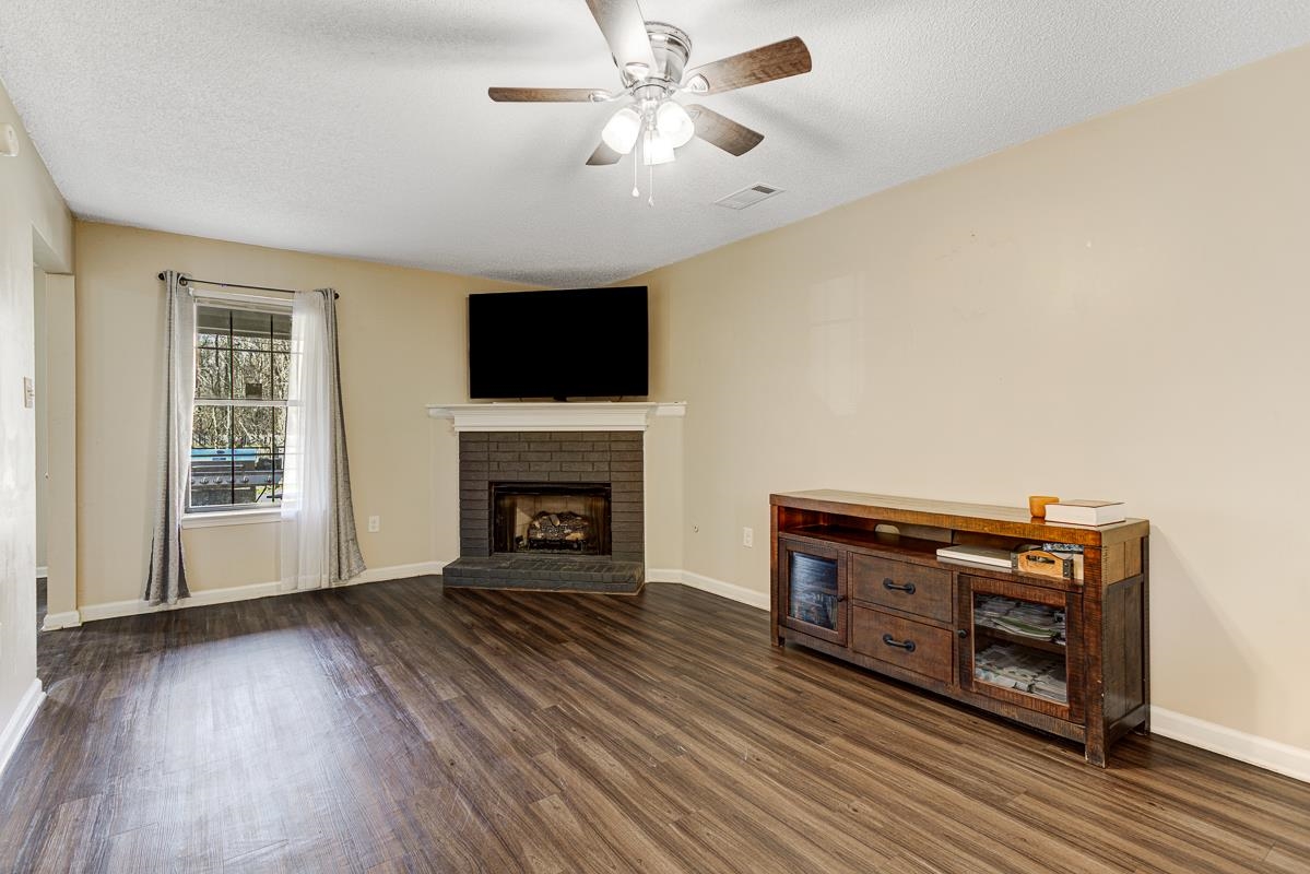 4464 Cedar Ridge Lane Memphis, TN 38128 - Photo 4 of 24 a living room with furniture a fireplace and a flat screen tv