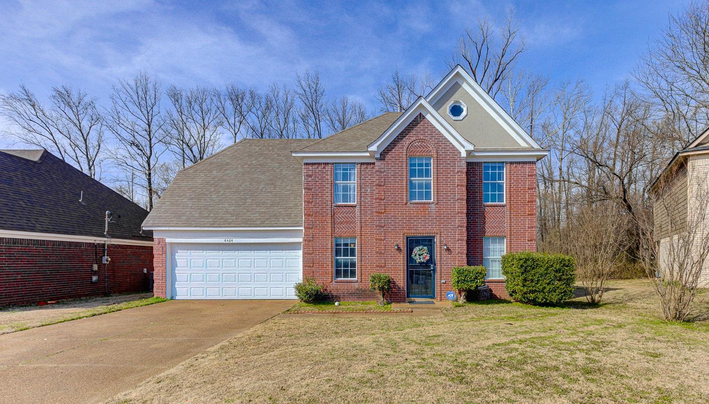 4464 Cedar Ridge Lane Memphis, TN 38128 - Photo 5 of 24 a front view of a house with a yard and garage
